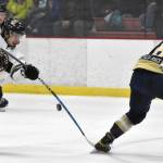 Kenai River Brown Bears forward Ashton Christman has his shot blocked by Janesville (Wisconsin) Jets defenseman Charlie Lieberman on Saturday, Feb. 25, 2023, at the Soldotna Regional Sports Complex. (Photo by Jeff Helminiak/Peninsula Clarion)