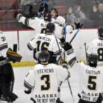 The Kenai River Brown Bears mob Ryan Finch after he scored the game-winning goal in overtime against the Janesville (Wisconsin) Jets on Saturday, Feb. 25, 2023, at the Soldotna Regional Sports Complex in Soldotna, Alaska. (Photo by Jeff Helminiak/Peninsula Clarion)