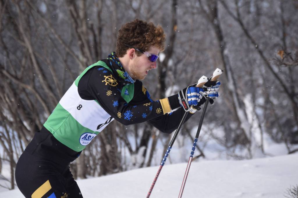Homers Seamus McDonough puts his sticks in the snow as he charges uphill during the second leg of the boys 4x5-kilometer relay at the ASAA State Nordic Ski Championships at Kincaid Park in Anchorage, Alaska, on Saturday, Feb. 25, 2023. (Jake Dye/Peninsula Clarion)