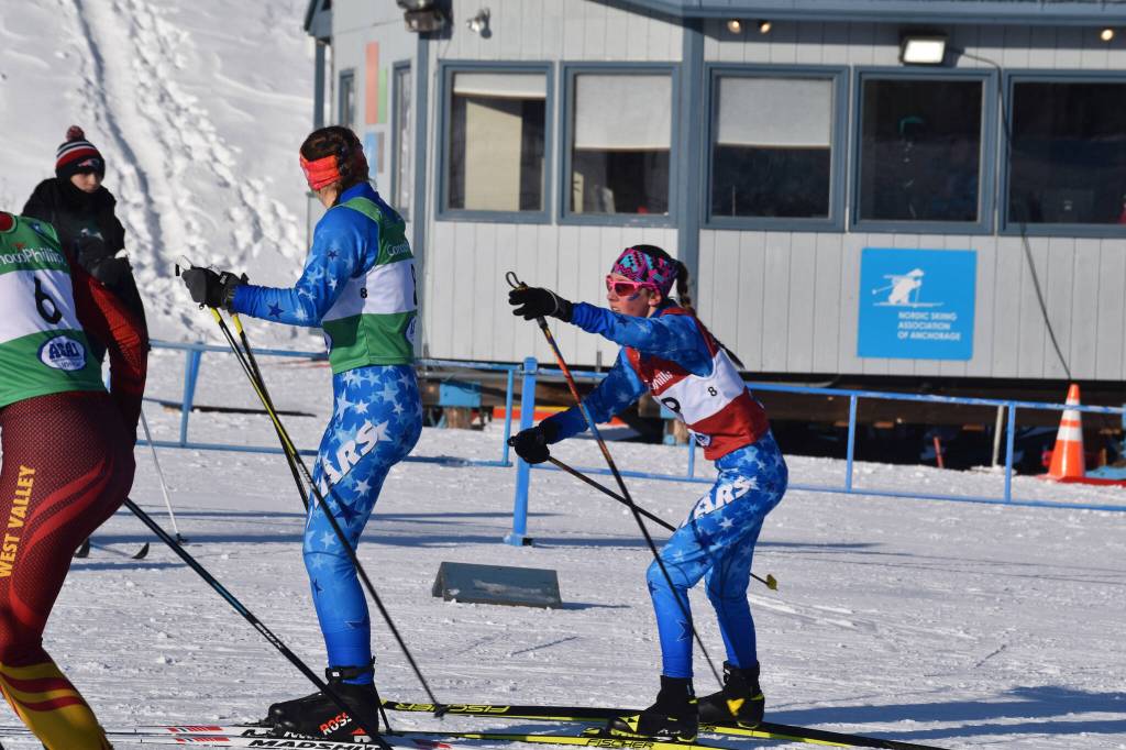 Soldotnas Tania Boonstra reaches out to tag off to teammate Ariana Cannava for the second leg of the girls 4x3.5-kilometer relay at the ASAA State Nordic Ski Championships at Kincaid Park in Anchorage, Alaska, on Saturday, Feb. 25, 2023. (Jake Dye/Peninsula Clarion)