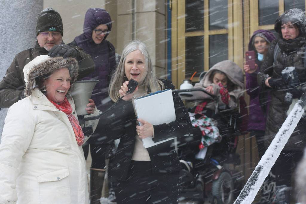 State Rep. Andi Story, D-Juneau, advocates for more state funding on behalf of Alaska residents with disabilities so they can live as independently as possible with the help of service providers during a rally in a heavy snowstorm at midday Wednesday on the steps of the Alaska State Capitol. (Mark Sabbatini / Juneau Empire)
