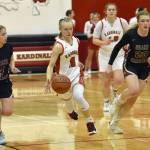 Kenai Centrals Rylie Sparks splits Grace Christians Poppy Wiggers-Pidduck and Sophie Lentfer on Friday, March 3, 2023, at Kenai Central High School in Kenai, Alaska. (Photo by Jeff Helminiak/Peninsula Clarion)