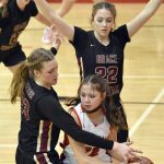 Kenai Centrals Emilee Wilson looks to escape the trap of Grace Christians Sophie Lentfer and Olivia Jones on Friday, March 3, 2023, at Kenai Central High School in Kenai, Alaska. (Photo by Jeff Helminiak/Peninsula Clarion)