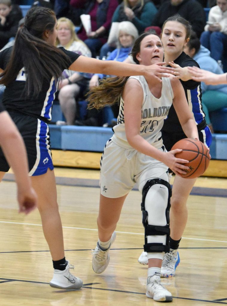 Soldotnas Josie Sheridan drives on Palmers Ariana Belk on Saturday, March 4, 2023, at Soldotna High School in Soldotna, Alaska. (Photo by Jeff Helminiak/Peninsula Clarion)