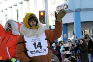 Defending champion Brent Sass, wearing bib No. 14, waves to the crowd during the Iditarod Trail Sled Dog Races ceremonial start in downtown Anchorage, Alaska, on Saturday, March 4, 2023. Sass withdrew from this years race, Saturday, March 11, 2023, citing concerns for his health. (AP Photo/Mark Thiessen, File)