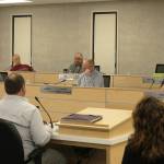 Foreground: Kenai Peninsula Borough School District Superintendent Clayton Holland, left, and KPBSD Finance Director Liz Hayes, right, speak about the districts fiscal year 2024 budget during a work session with the Kenai Peninsula Borough Assembly on Tuesday, March 14, 2023, in Soldotna, Alaska. (Ashlyn OHara/Peninsula Clarion)