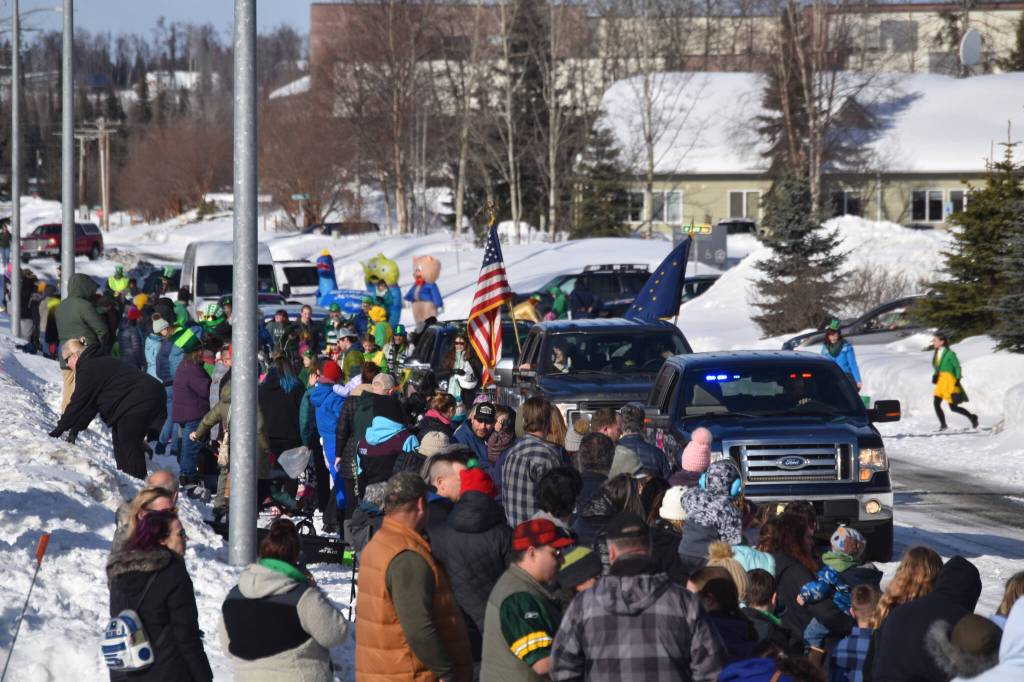 A crowd of parents and children line the sidewalk as the 32nd annual Sweeneys St. Patricks Day Parade proceeds down Fireweed Street in Soldotna, Alaska on Friday, March 17, 2023. (Jake Dye/Peninsula Clarion)