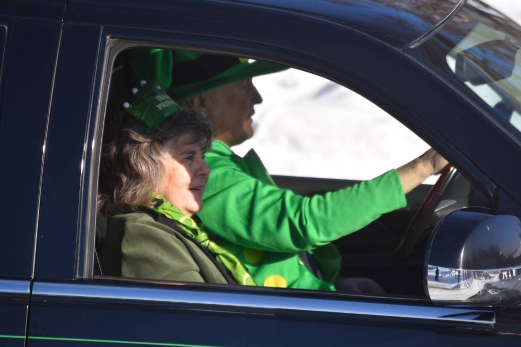 Gloria Sweeney and Mike Sweeney ride and wave as the 32nd annual Sweeneys St. Patricks Day Parade proceeds down Fireweed Street in Soldotna, Alaska on Friday, March 17, 2023. (Jake Dye/Peninsula Clarion)