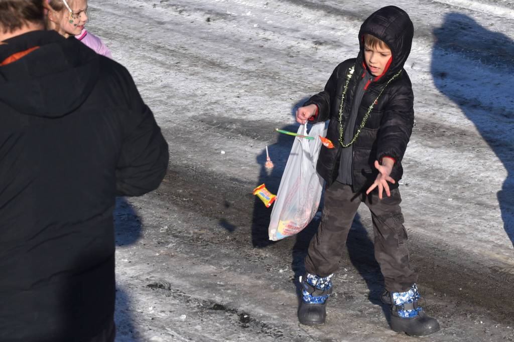 Candy is thrown as the 32nd annual Sweeneys St. Patricks Day Parade proceeds down Fireweed Street in Soldotna, Alaska on Friday, March 17, 2023. (Jake Dye/Peninsula Clarion)