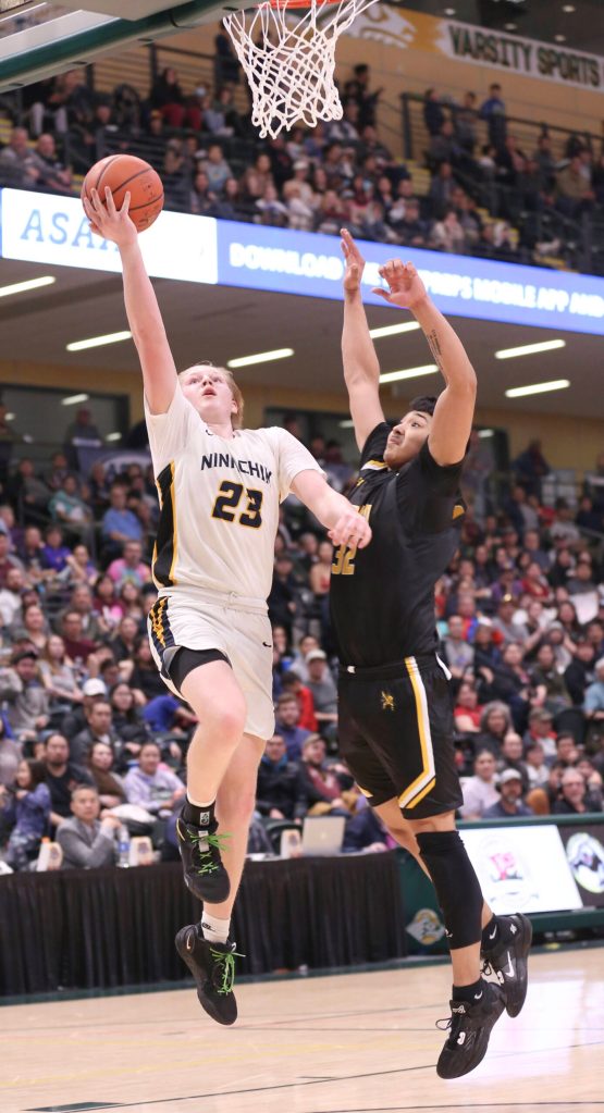 Ninilchiks Cole Moore drives against Tikigaqs Midas Tuzroyluk during the Class 2A boys state championship Saturday, March 18, 2023, at the Alaska Airlines Center in Anchorage, Alaska. (Photo courtesy of Robin Moore)