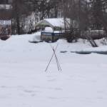 A tripod set by the Soldotna and Kenai Rotary Clubs stands over the ice of the Kenai River in Soldotna, Alaska on Tuesday, March 28, 2023. (Jake Dye/Peninsula Clarion)