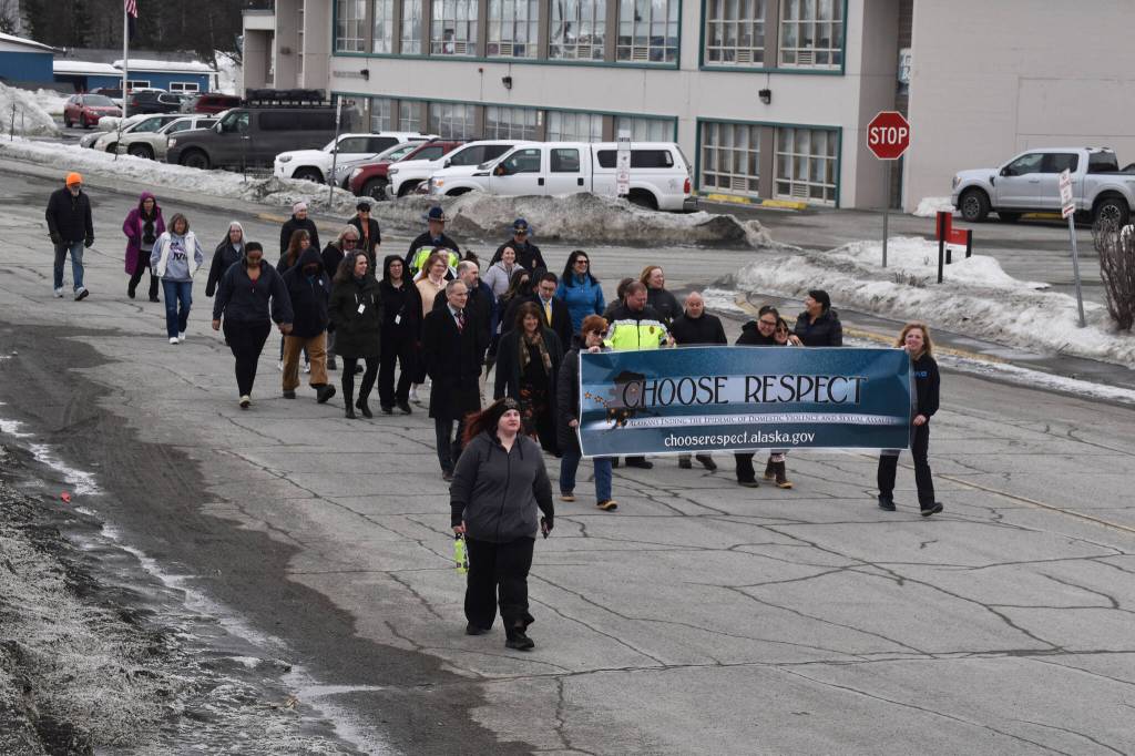 The 11th Annual Alaskans Choose Respect Awareness Event proceeds down Frontage Road in Kenai, Alaska on Wednesday, March 29, 2023. (Jake Dye/Peninsula Clarion)