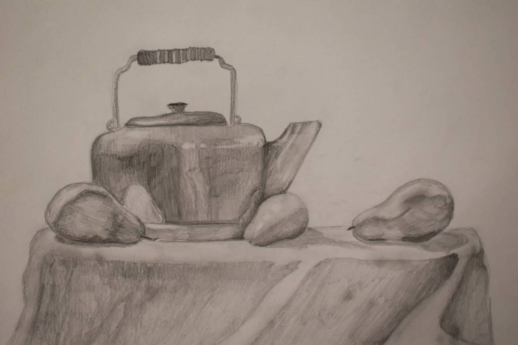A drawing of a kettle and some pears hangs at the Kenai Art Center in Kenai, Alaska on Wednesday, April 5, 2023, in preparation for the debut of the 32nd Annual Kenai Peninsula Borough School District Visual Feast. (Jake Dye/Peninsula Clarion)