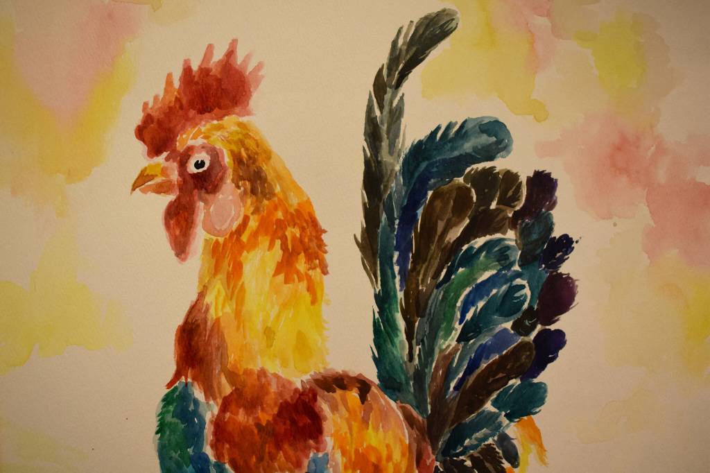 A colorful painting of a rooster hangs at the Kenai Art Center in Kenai, Alaska on Wednesday, April 5, 2023, in preparation for the debut of the 32nd Annual Kenai Peninsula Borough School District Visual Feast. (Jake Dye/Peninsula Clarion)