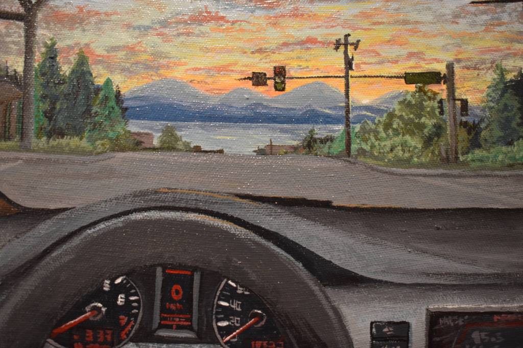 A painting depicting the point of view of a driver at an intersection hangs at the Kenai Art Center in Kenai, Alaska on Wednesday, April 5, 2023, in preparation for the debut of the 32nd Annual Kenai Peninsula Borough School District Visual Feast. (Jake Dye/Peninsula Clarion)
