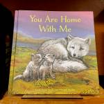 The childrens book You Are Home With Me, illustrated by Mitchell Thomas Watley, is shown at a bookstore in Portland, Ore. in this April 5, 2023 photo. Publisher Sasquatch books, owned by Penguin Random House, said Wednesday, it has ended its publishing relationship with Watley after he was arrested on allegations of leaving violent, transphobic notes in stores around Juneau, Alaska. Watley told police he was motivated by fear following a deadly school shooting in Nashville that sparked online backlash about the shooters gender identity, court records show. (AP Photo/Claire Rush)