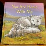 The childrens book You Are Home With Me, illustrated by Mitchell Thomas Watley, is shown at a bookstore in Portland, Ore. in this April 5, 2023 photo. Publisher Sasquatch books, owned by Penguin Random House, said Wednesday, April 5, 2023, it has ended its publishing relationship with Watley after he was arrested on allegations of leaving violent, transphobic notes in stores around Juneau, Alaska. Watley told police he was motivated by fear following a deadly school shooting in Nashville that sparked online backlash about the shooters gender identity, court records show. (AP Photo/Claire Rush)