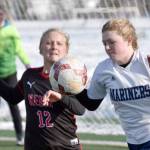 Kenai Central's Kate Wisnewski and Homer's Talia Weisser battle for the ball Thursday, April 6, 2023, at Ed Hollier Field at Kenai Central High School in Kenai, Alaska. (Photo by Jeff Helminiak/Peninsula Clarion)