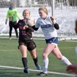 Kenai Central's Kate Wisnewski and Homer's Talia Weisser battle for the ball Thursday, April 6, 2023, at Ed Hollier Field at Kenai Central High School in Kenai, Alaska. (Photo by Jeff Helminiak/Peninsula Clarion)