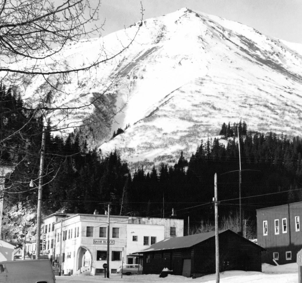 Below the snowy slopes of Mount Marathon stands a building labeled Bank Block, which in August 1971 contained the city of Sewards only bank. (Photo #44.1.7 courtesy of the Resurrection Bay Historical Society)
