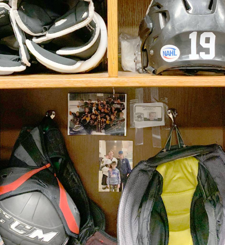 The locker of Brown Bears forward Parker Lockwood is decorated with momentos that remind him of his path to the team. At top left is a picture of Lockwoods Kenai Peninsula Hockey Association team. At top right is a season pass to the Brown Bears games Lockwood got for the 2010-11 season. At bottom is a picture of Parker, Parkers brother Dawson Lockwood, and young fan Kevin Michael. Michael printed out the picture and asked Lockwood to hang it in his locker. (Photo provided)