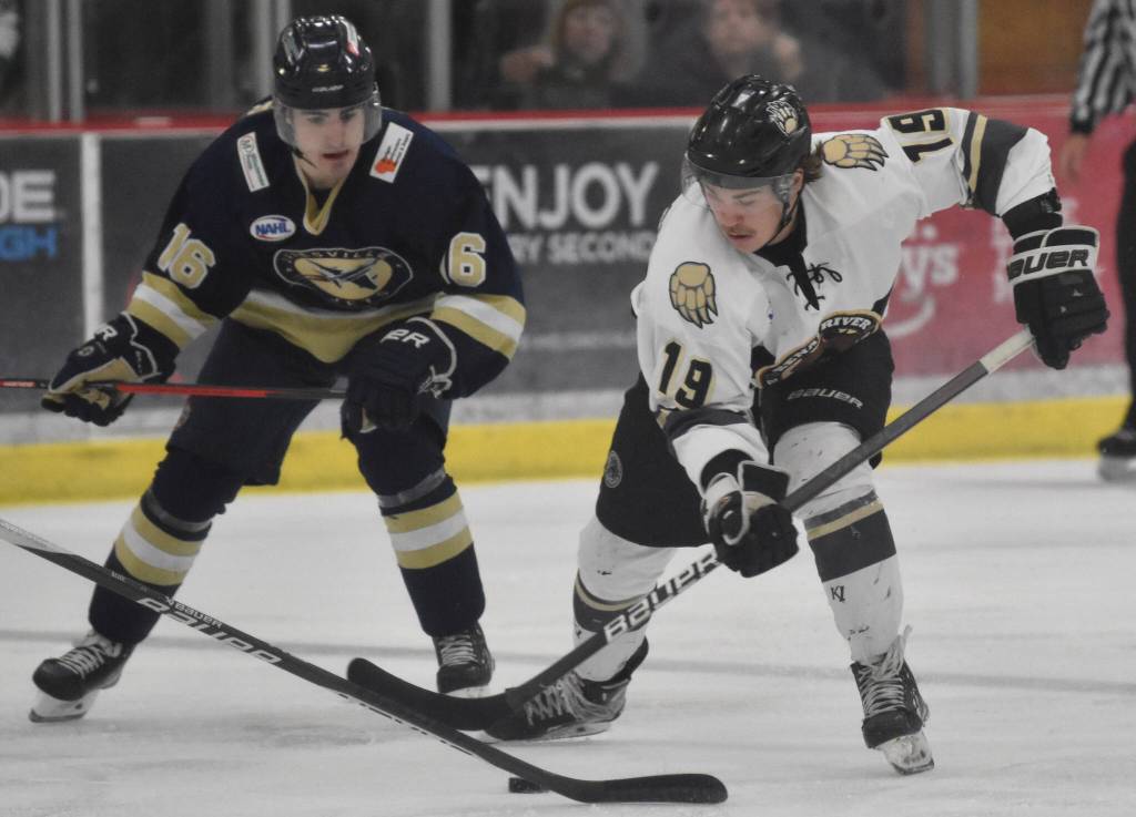Kenai River Brown Bears forward Parker Lockwood protects the puck from Max Wagener of the Janesville (Wisconsin) Jets on Saturday, Feb. 25, 2023, at the Soldotna Regional Sports Complex in Soldotna, Alaska. (Photo by Jeff Helminiak/Peninsula Clarion)