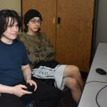 Kenai Centrals Eli Castro competes while spectated by teammate Kaizen Fuller in the playoffs for Alaska high school Super Smash Bros. Ultimate on Friday, April 14, 2023 at Kenai Central High School in Kenai, Alaska. (Jake DyePeninsula Clarion)