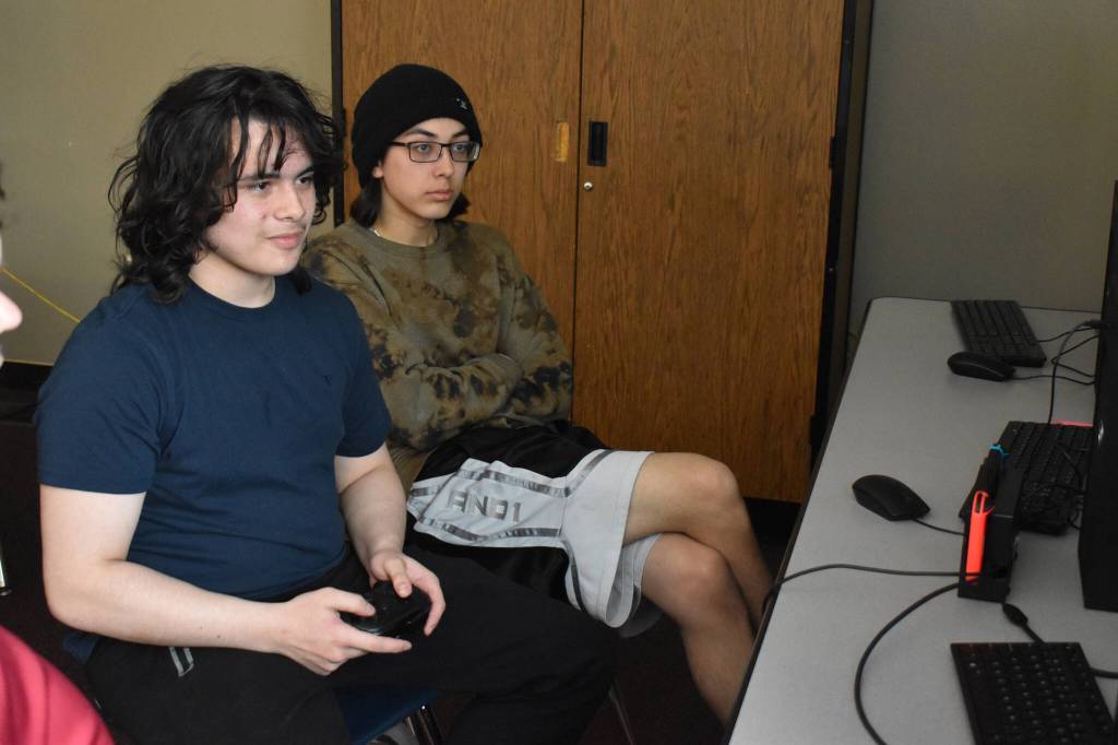 Kenai Centrals Eli Castro competes while spectated by teammate Kaizen Fuller in the playoffs for Alaska high school Super Smash Bros. Ultimate on Friday, April 14, 2023 at Kenai Central High School in Kenai, Alaska. (Jake DyePeninsula Clarion)