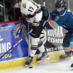 Kenai River Brown Bears forward Owen Hanson and Anchorage Wolverines defenseman Peyton Van Buskirk battle for the puck Saturday, April 25, 2023, at the Soldotna Regional Sports Complex in Soldotna, Alaska. (Photo by Jeff Helminiak/Peninsula Clarion)