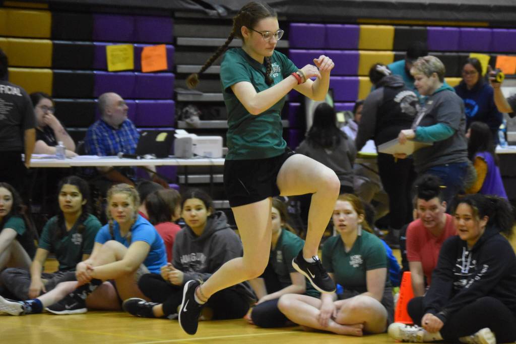 A Homer athlete competing in the senior division performs the Scissor Broad Jump during the Salamatof Tribe Traditional Native Games Invitational at Kenai Middle School in Kenai, Alaska, on Friday, April 14, 2023. (Jake Dye/Peninsula Clarion)