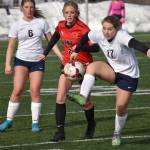 Soldotnas Liberty Miller controls the ball in front of Kenai Centrals Kori Moore and Soldotnas Alex Lee on Tuesday, April 18, 2023, at Ed Hollier Field at Kenai Central High School in Kenai, Alaska. (Photo by Jeff Helminiak/Peninsula Clarion)
