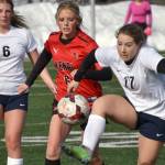 Soldotna's Liberty Miller controls the ball in front of Kenai Central's Kori Moore and Soldotna's Alex Lee on Tuesday, April 18, 2023, at Ed Hollier Field at Kenai Central High School in Kenai, Alaska. (Photo by Jeff Helminiak/Peninsula Clarion)
