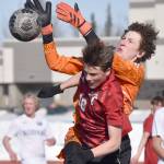 Kodiak goalie Dexter Smith and Kenai Centrals Sawyer Vann battle for the ball Thursday, April 20, 2023, at Ed Hollier Field at Kenai Central High School in Kenai, Alaska. (Photo by Jeff Helminiak/Peninsula Clarion)