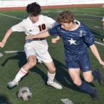 Kellen Chester of Juneau-Douglas: Yadaa.at Kale and Owen Buckbee of Soldotna battle for the ball Friday, April 21, 2023, at Ed Hollier Field at Kenai Central High School in Kenai, Alaska. (Photo by Jeff Helminiak/Peninsula Clarion)