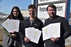 Kenai Peninsula reporter Ashlyn OHara, Sports Editor Jeff Helminiak and reporter Jake Dye pose with their 2022 Alaska Press Club awards, Monday, April 24, 2023, in Kenai, Alaska. (Photo by Erin Thompson/Peninsula Clarion)