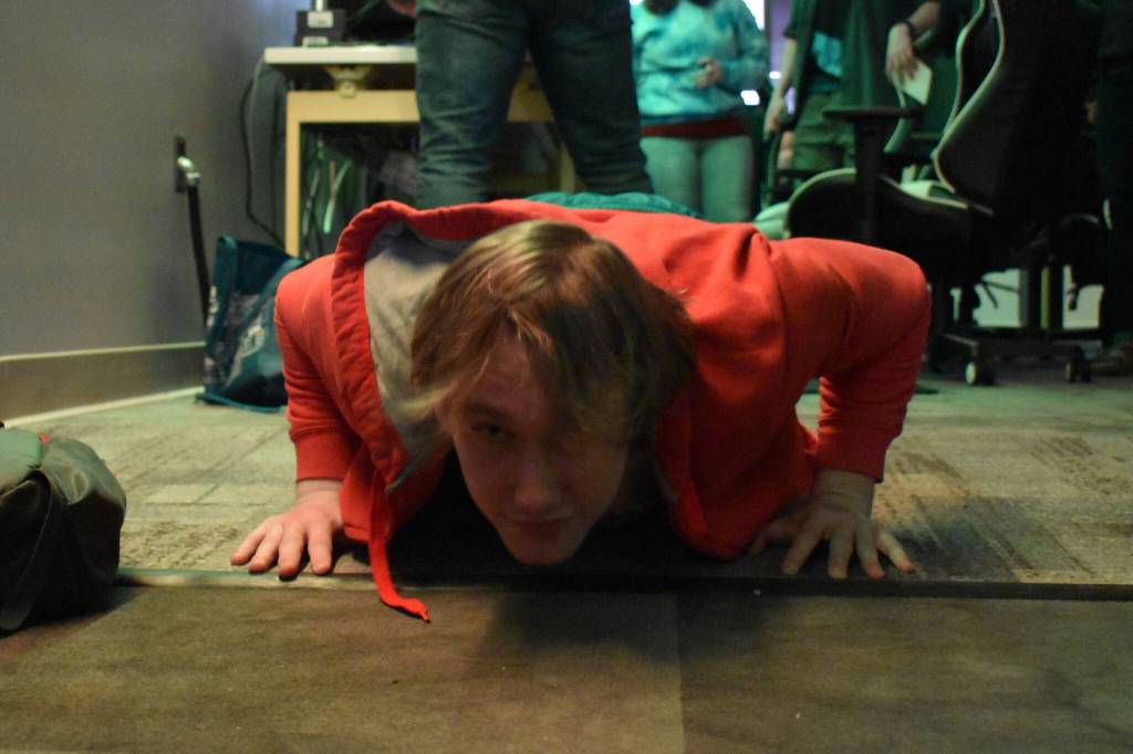 Kenai Centrals Kage Adkins does push ups after his loss during the Super Smash Bros. Ultimate State Championship on Saturday, April 22, 2023, at the University of Alaska Anchorage Esports Lounge in Anchorage, Alaska. (Jake Dye/Peninsula Clarion)
