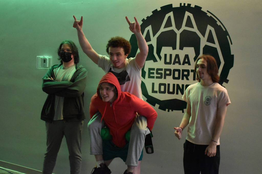 Kenai Centrals Landon Dubber, Silas Thibodeau, Kage Adkins and Cody Good stand together for a photo after their last match on Saturday, April 22, 2023, at the University of Alaska Anchorage Esports Lounge in Anchorage, Alaska. (Jake Dye/Peninsula Clarion)