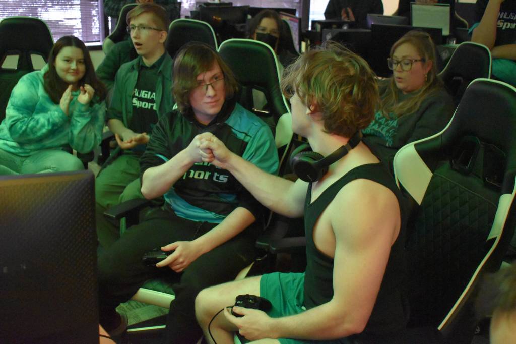 Chugiaks Addison Rains and Kenais Kage Adkins pound knuckles between rounds while they compete in the final match of the Super Smash Bros. Ultimate State Championship on Saturday, April 22, 2023, at the University of Alaska Anchorage Esports Lounge in Anchorage, Alaska. (Jake Dye/Peninsula Clarion)