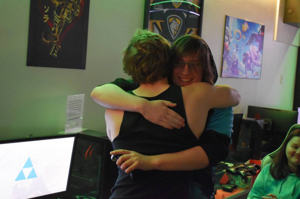 Kenai Centrals Kage Adkins shares a hug with Chugiaks Addison Rains after the last match of the Super Smash Bros. Ultimate State Championship on Saturday, April 22, 2023, at the University of Alaska Anchorage Esports Lounge in Anchorage, Alaska. (Jake Dye/Peninsula Clarion)