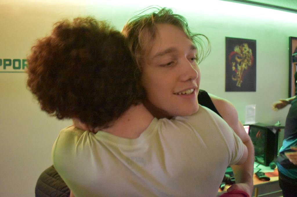 Kenai Centrals Silas Thibodeau and Kage Adkins share a hug after the last match of the Super Smash Bros. Ultimate State Championship on Saturday, April 22, 2023, at the University of Alaska Anchorage Esports Lounge in Anchorage, Alaska. (Jake Dye/Peninsula Clarion)