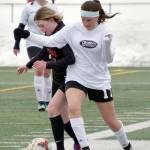 Kenai Centrals Tait Cooper and Nikiskis Savanna Stock battle for the ball Tuesday, April 25, 2023, at Ed Hollier Field at Kenai Central High School in Kenai, Alaska. (Photo by Jeff Helminiak/Peninsula Clarion)