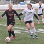 Kenai Centrals Kate Wisnewski shields the ball from Nikiskis Wynter Yeager on Tuesday, April 25, 2023, at Ed Hollier Field at Kenai Central High School in Kenai, Alaska. (Photo by Jeff Helminiak/Peninsula Clarion)