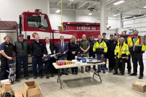 Kenai Peninsula Borough Mayor Peter Micciche (fifth from left) celebrates the receipt of extrication equipment alongside staff from Kenai Peninsula fire departments and the Girdwood Fire Department during a press event at the Girdwood Fire Department on Tuesday, April 25, 2023, in Girdwood, Alaska. (Photo courtesy Kenai Peninsula Borough Mayors Office)