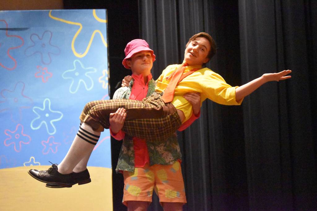 Oliver Parrish portraying Patrick Star, lifts Jackson Hooper as SpongeBob during a rehearsal of SpongeBob SquarePants on Saturday, April 15, 2023, at Nikiski Middle/High School in Nikiski, Alaska. (Jake Dye/Peninsula Clarion)