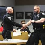 Soldotna Police Chief Gene Meek, left, presents Officer David Bower with a Lifesaver Award during a Soldotna City Council meeting on Wednesday, April 26, 2023, in Soldotna, Alaska. (Ashlyn OHara/Peninsula Clarion)