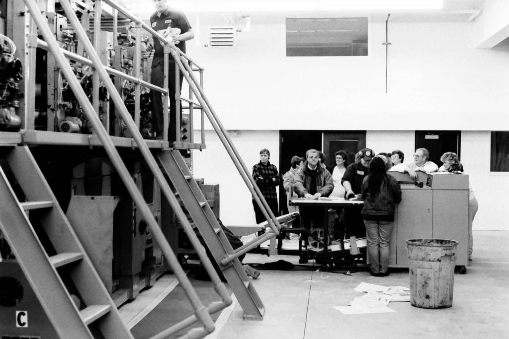 Roy Shapley/Peninsula Clarion file
Peninsula Clarion staff gather around the Goss Suburban during an opening event in December 1992 in the Peninsula Clarion pressroom in Kenai, Alaska.