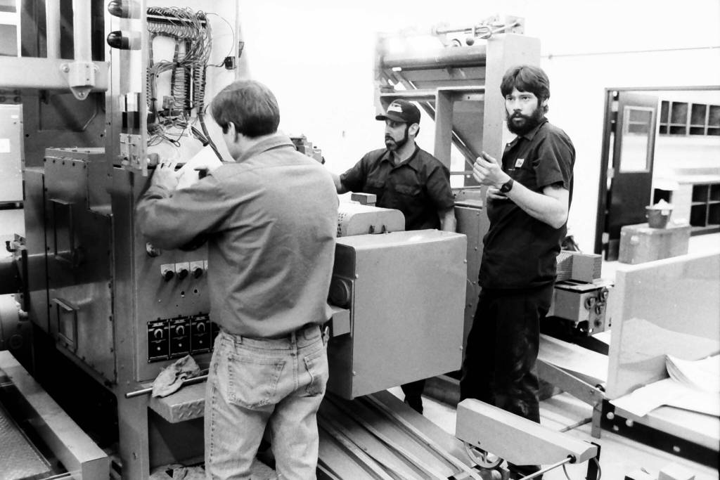 Pressmen stand around the Goss Suburban on its opening day in December 1992 in the Peninsula Clarion pressroom in Kenai, Alaska. (Roy Shapeley/Peninsula Clarion)