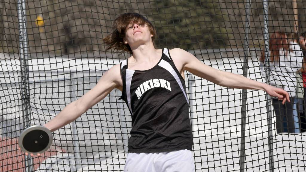 Nikiskis Dalton Goodnight throws the discus Saturday, April 29, 2023, at Ed Hollier Field at Kenai Central High School in Kenai, Alaska. (Photo by Jeff Helminiak/Peninsula Clarion)