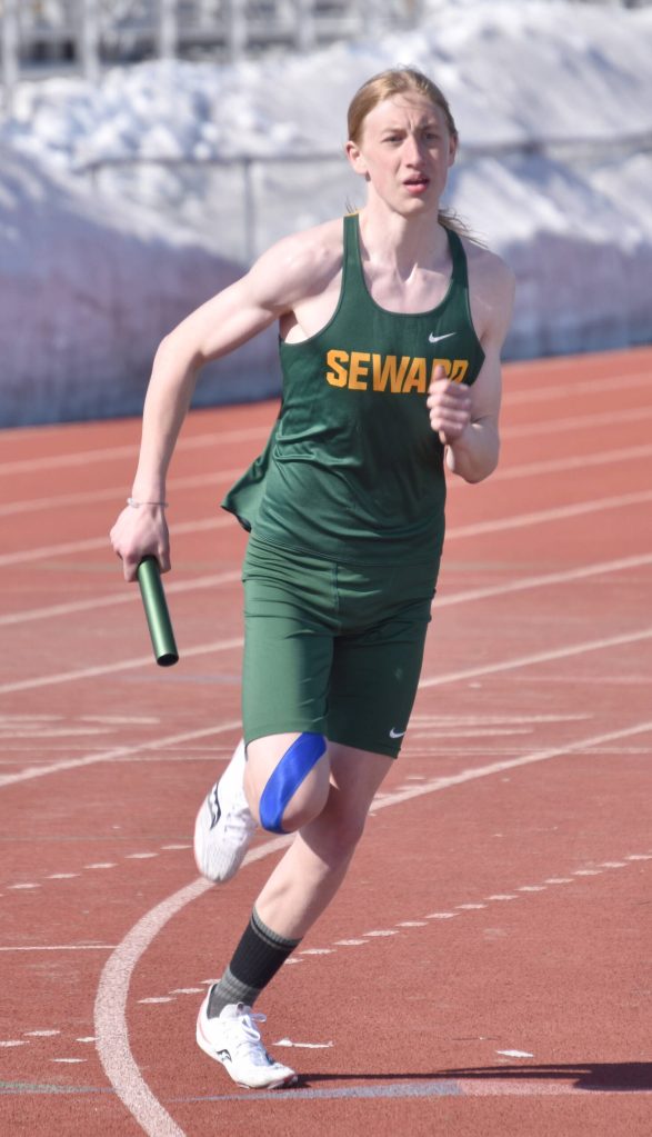 Sewards Olin Liljemark races the 1,600-meter relay Saturday, April 29, 2023, at Ed Hollier Field at Kenai Central High School in Kenai, Alaska. (Photo by Jeff Helminiak/Peninsula Clarion)