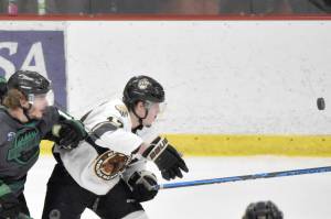 Brian Lonergan and Sawyer Scholl of the Minnesota Wilderness and Owen Hanson of the Kenai River Brown Bears eye the puck Friday, April 28, 2023, at the Soldotna Regional Sports Complex in Soldotna, Alaska. (Photo by Jeff Helminiak/Peninsula Clarion)